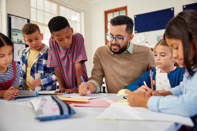 Teacher writing with elementary school students